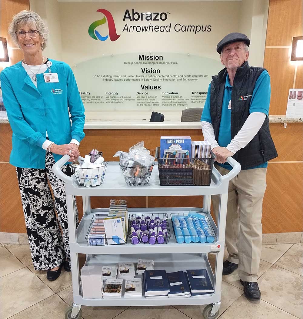 Volunteers with resource cart at hospital lobby