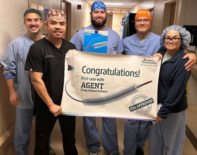 Medical team holding congratulatory procedure banner