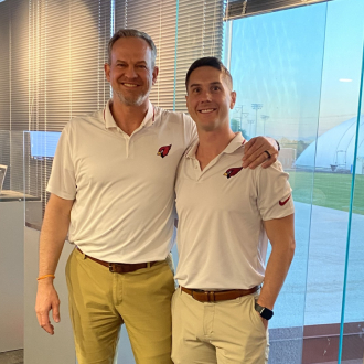Two people posing together in office