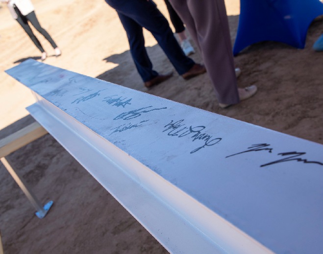 Signed steel beam at construction ceremony