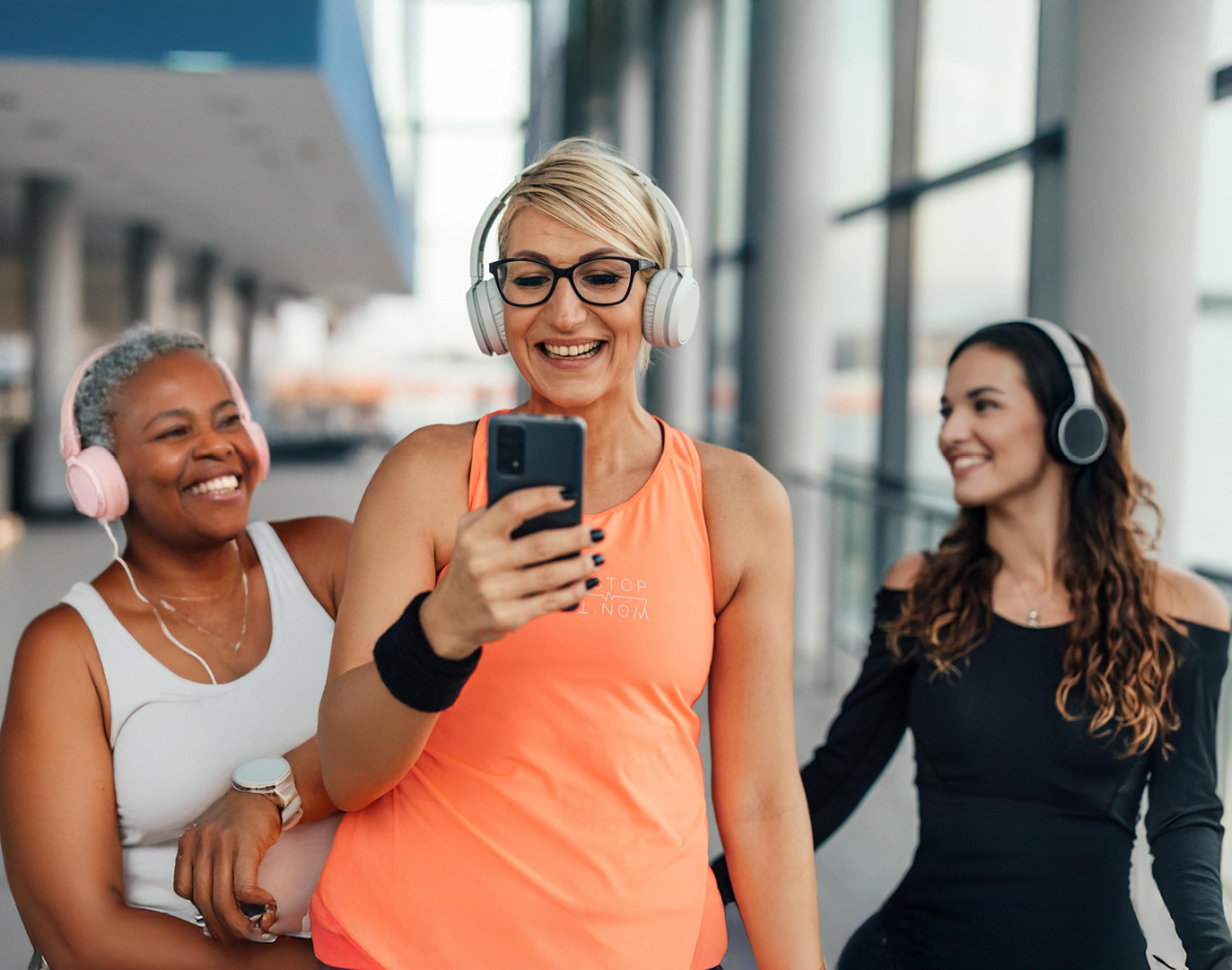 Group walking with headphones indoors gym