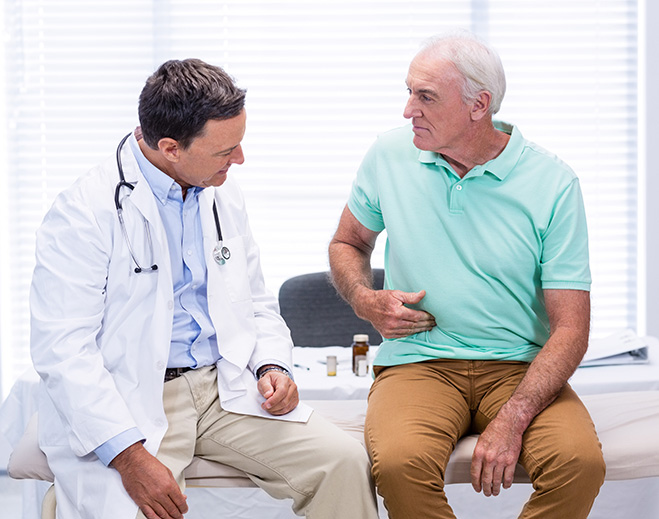 Doctor talking with patient in exam room