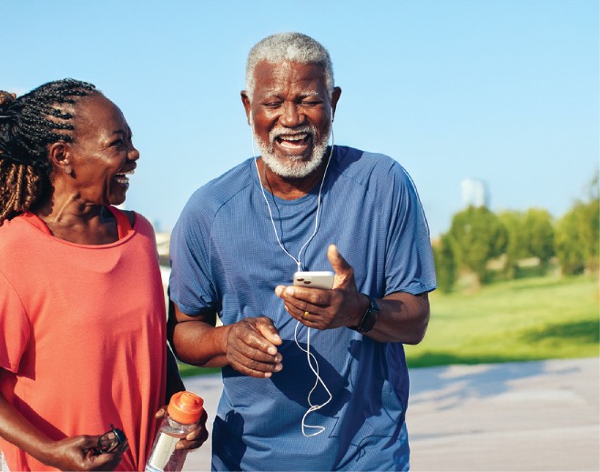 Two adults walking outdoors with phone