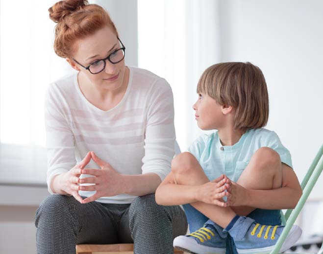 Adult and child sitting and talking together