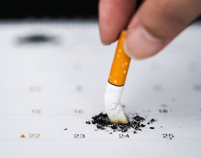 Stubbed cigarette on calendar date