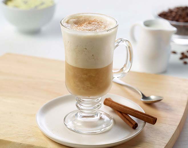 Latte with foam and cinnamon stick