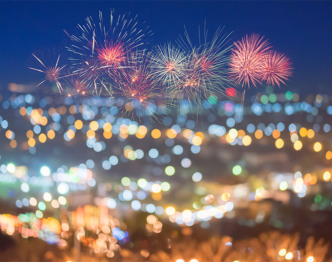 Fireworks over city lights at night