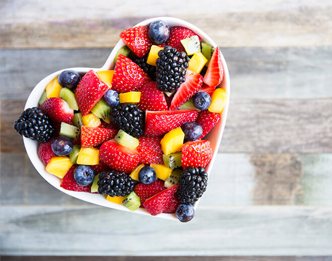 Heart shaped bowl filled with mixed fruit