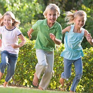 Children running and playing on grass