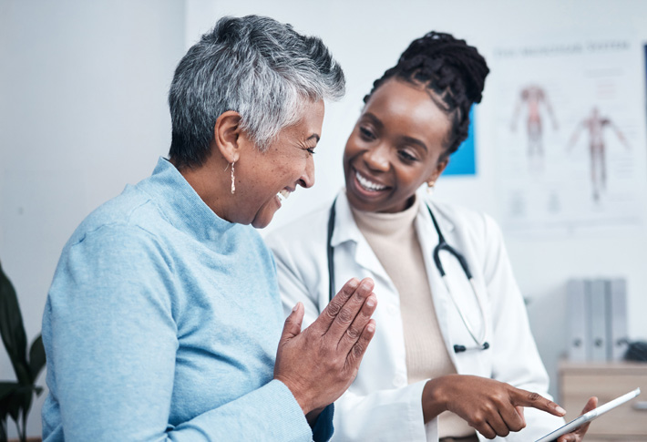 Doctor showing spine model to patient